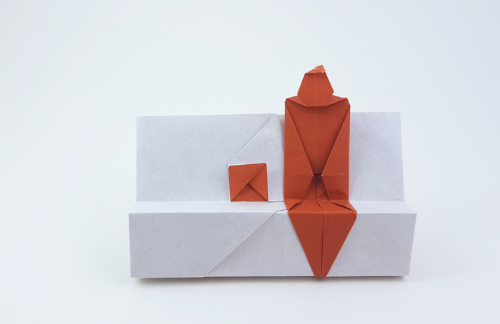 Origami Person sitting on a bench by Ashimura Shun'ichi. Folded from a square of origami paper by Gilad Aharoni on giladorigami.com