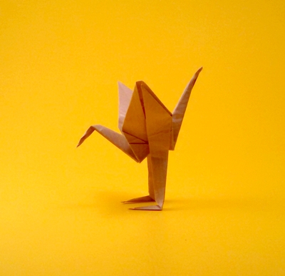 Origami Crane with legs by Juan David Herrera Cuartas. Folded from a triangle of Kraft origami paper by Gilad Aharoni on giladorigami.com