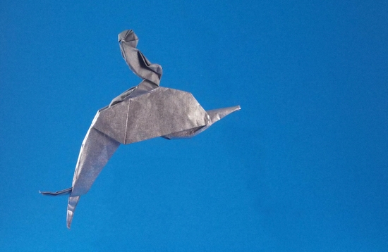 Origami Boy on dolphin by Robert Harbin. Folded from a square of Nicolas Terry's tissue-foil by Gilad Aharoni on giladorigami.com