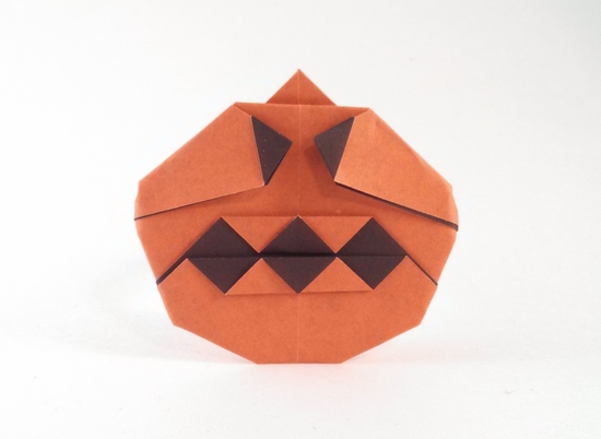 Origami Jack-o'-lantern by Nick Robinson. Folded from a square of duo origami paper by Gilad Aharoni on giladorigami.com