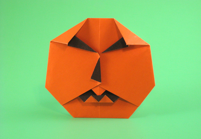 Origami Jack-o'-lantern by Sy Chen. Folded from a square of duo origami paper by Gilad Aharoni on giladorigami.com