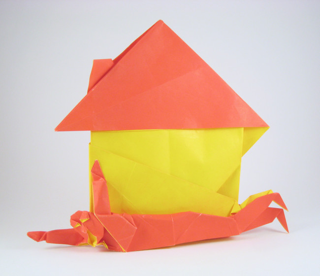 Origami Man under house - mortgage by Fernando Gilgado Gomez. Folded from a square of duo origami paper by Gilad Aharoni on giladorigami.com