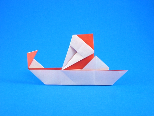 Origami Santa on sled by Niwa Taiko. Folded from a square of origami paper by Gilad Aharoni on giladorigami.com