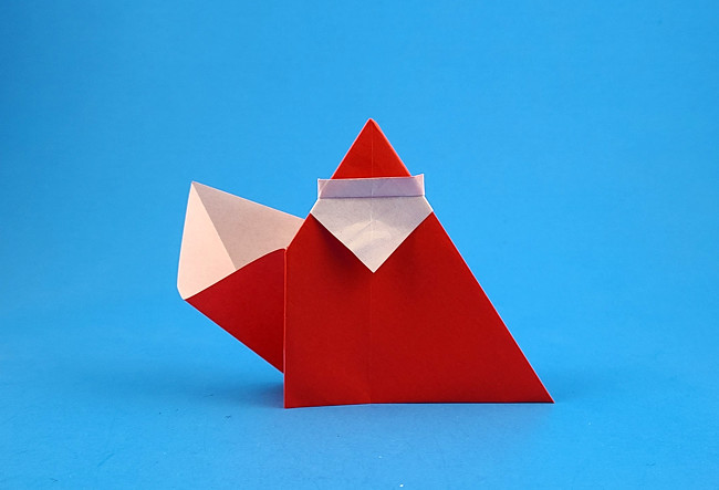 Origami Santa Claus with bag by Bernie Peyton. Folded from a square of origami paper by Gilad Aharoni on giladorigami.com