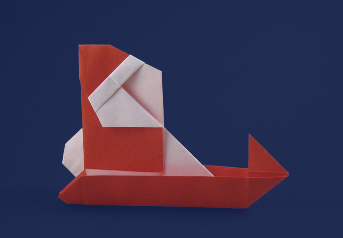 Origami Santa Claus and sled by Sanae Sakai. Folded from a square of origami paper by Gilad Aharoni on giladorigami.com