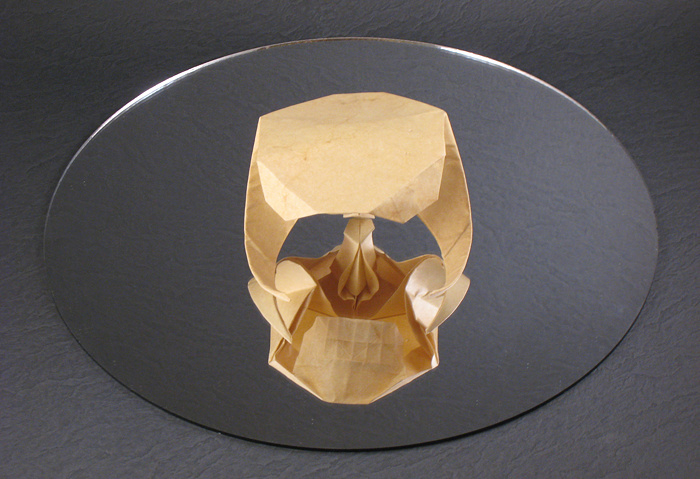 Origami Skull by Herman van Goubergen. Wet-folded from a square of Elephant-Hide and placed on a mirror by Gilad Aharoni on giladorigami.com