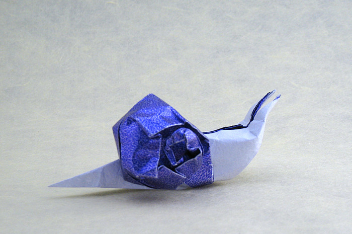 Origami Snail by Jozsef Zsebe. Folded from a square of Kathy Stevick's tissue-foil by Gilad Aharoni on giladorigami.com