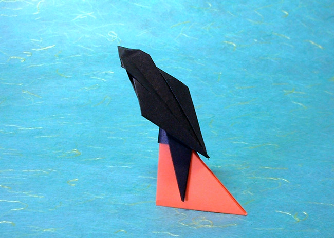 Origami Swallow by Toshikazu Kawasaki. Folded from a square of origami paper. Stand folded from another square by Gilad Aharoni on giladorigami.com