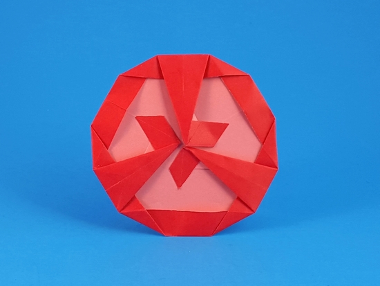 Origami Tomato slice by Nicolas Gajardo Henriquez. Folded from a triangle of duo origami paper by Gilad Aharoni on giladorigami.com