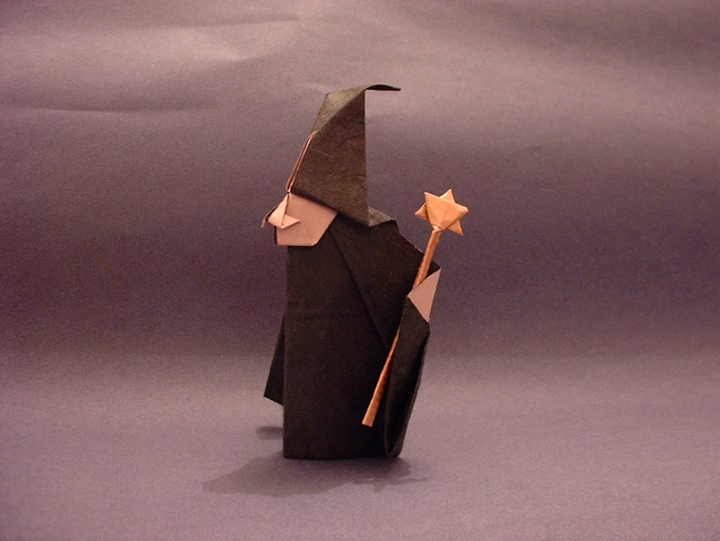 Origami Witch by Akira Yoshizawa. Folded from a square of rice paper, and the wand from another rectangle by Gilad Aharoni on giladorigami.com